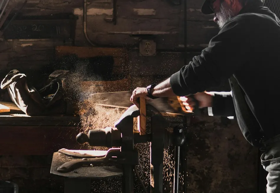 Woodworker shaping a piece of timber at the workbench