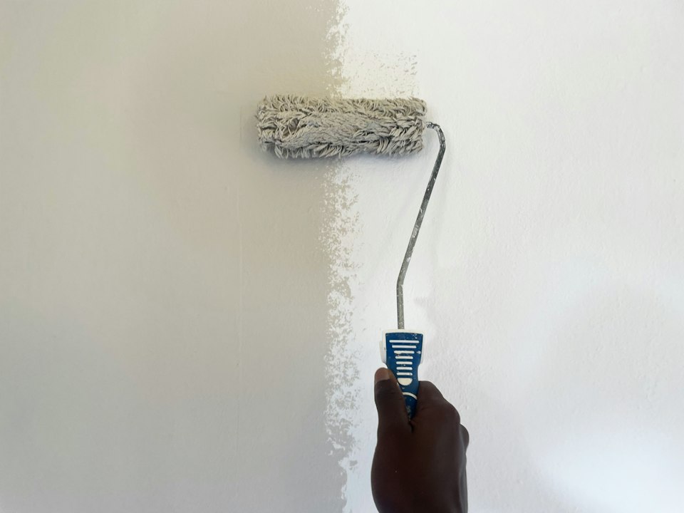 Painter working on interior wall