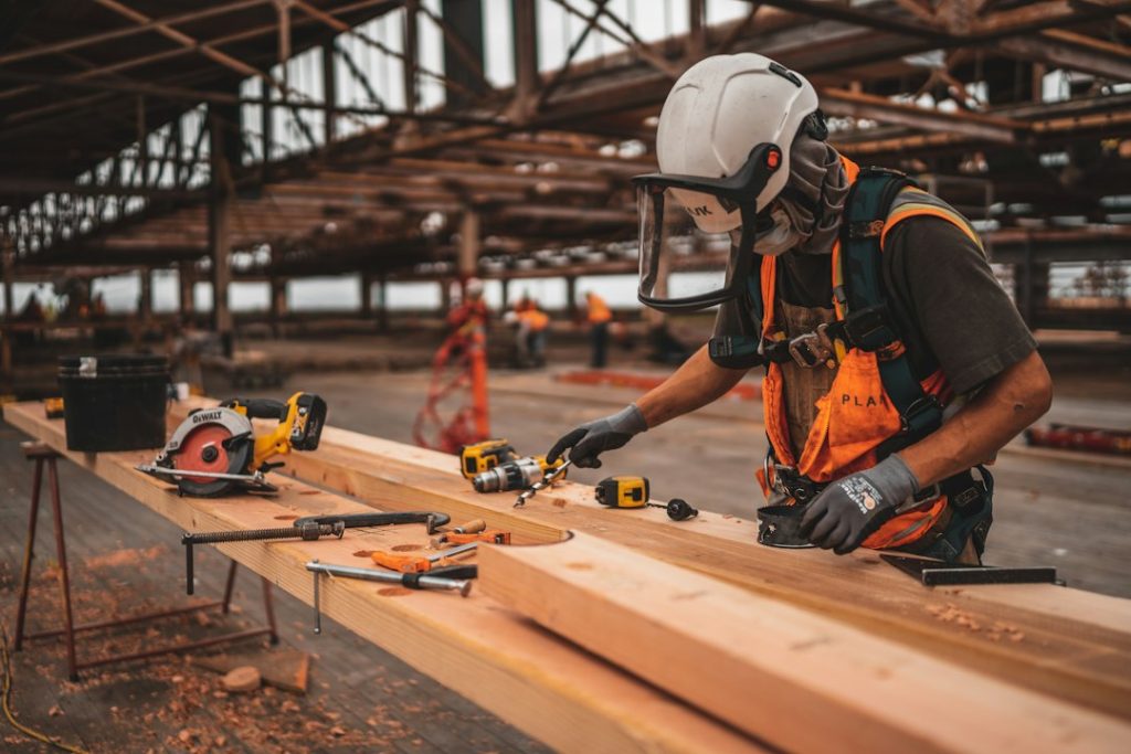 Worker using a power tool at a construction site